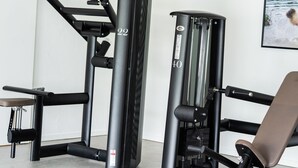 A gym with exercise equipment, including a pull-up bar and a chest press machine.