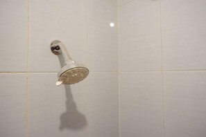 A showerhead mounted on a tiled wall. - Reddoorz @ Jalan Wonosari Km.9 (Yogyakarta)