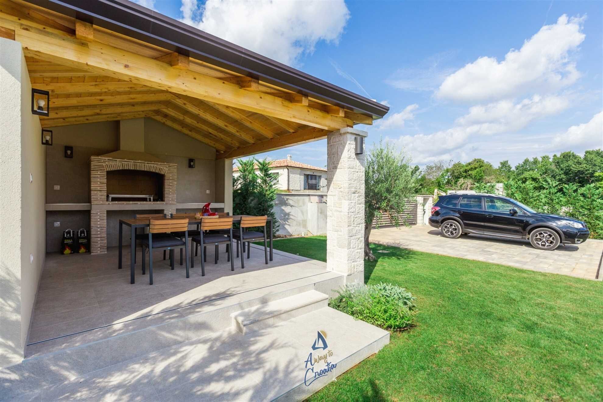 An outdoor patio with a built-in grill and seating area.