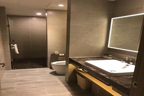 A modern bathroom with a large mirror, a sink, and a toilet. - Atour Hotel (Shenzhen)