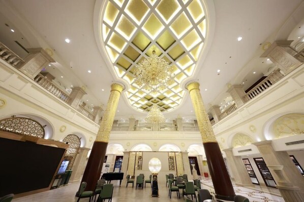 A grand lobby with a high ceiling, ornate columns, and a central chandelier. - Nanjing Suning Universal Hotel (Nanjing)