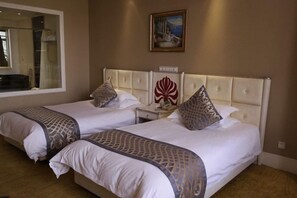 A hotel room with two beds, a large window, a painting on the wall, and a nightstand with a lamp. - Nanjing Suning Universal Hotel (Nanjing)
