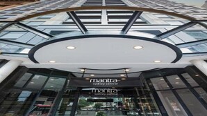 The exterior of a modern building with a curved glass facade and a sign reading "mantra sydney central". - Mantra Sydney Central (Sydney)