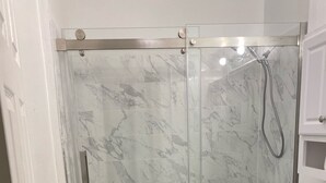A bathroom with a glass-enclosed shower, a toilet, and a sink. - Two Families, up and Down Stairs, the 2nd Floor is the Vrbos Apartment (New Britain)