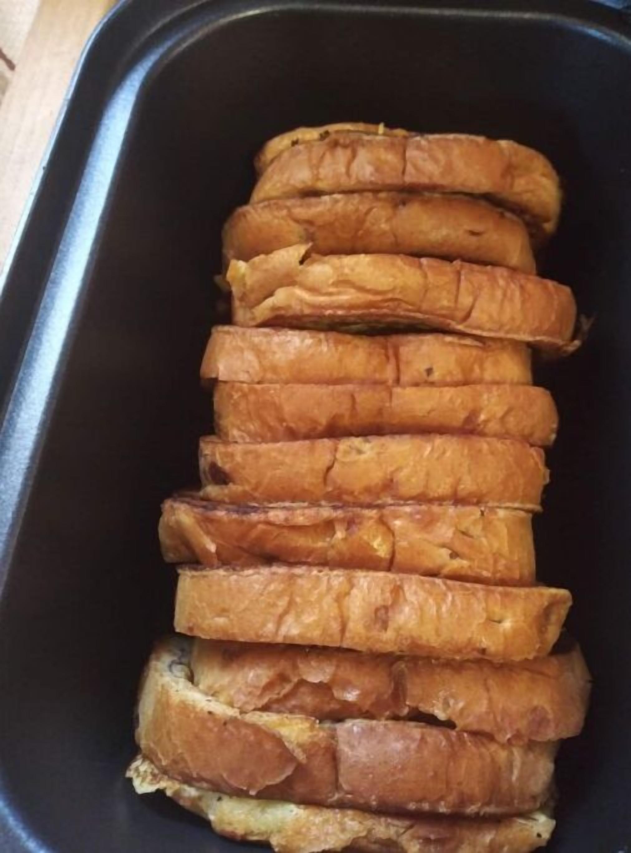 A black tray containing several slices of toasted bread.
