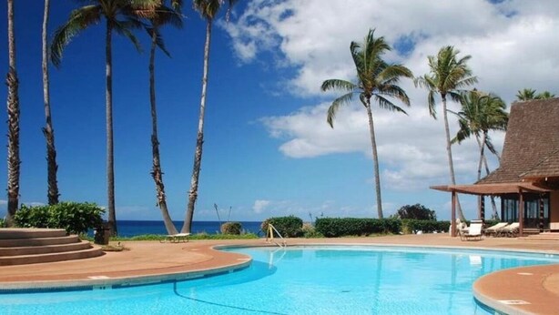 A clear blue pool surrounded by palm trees and a beach view. - West Molokai. Remote and Private. Hawaii's best. Ocean view Watch the Whales (Maunaloa)