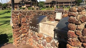 A stone barbecue area with a 'No Smoking' sign, a grill, and a stone wall. - West Molokai. Remote and Private. Hawaii's best. Ocean view Watch the Whales (Maunaloa)