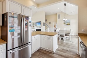 A modern kitchen with white cabinetry, stainless steel appliances, and a wooden countertop. - Sea n Stars: Pool, Hot Tub, 5-Min Walk to Beach (Corolla)