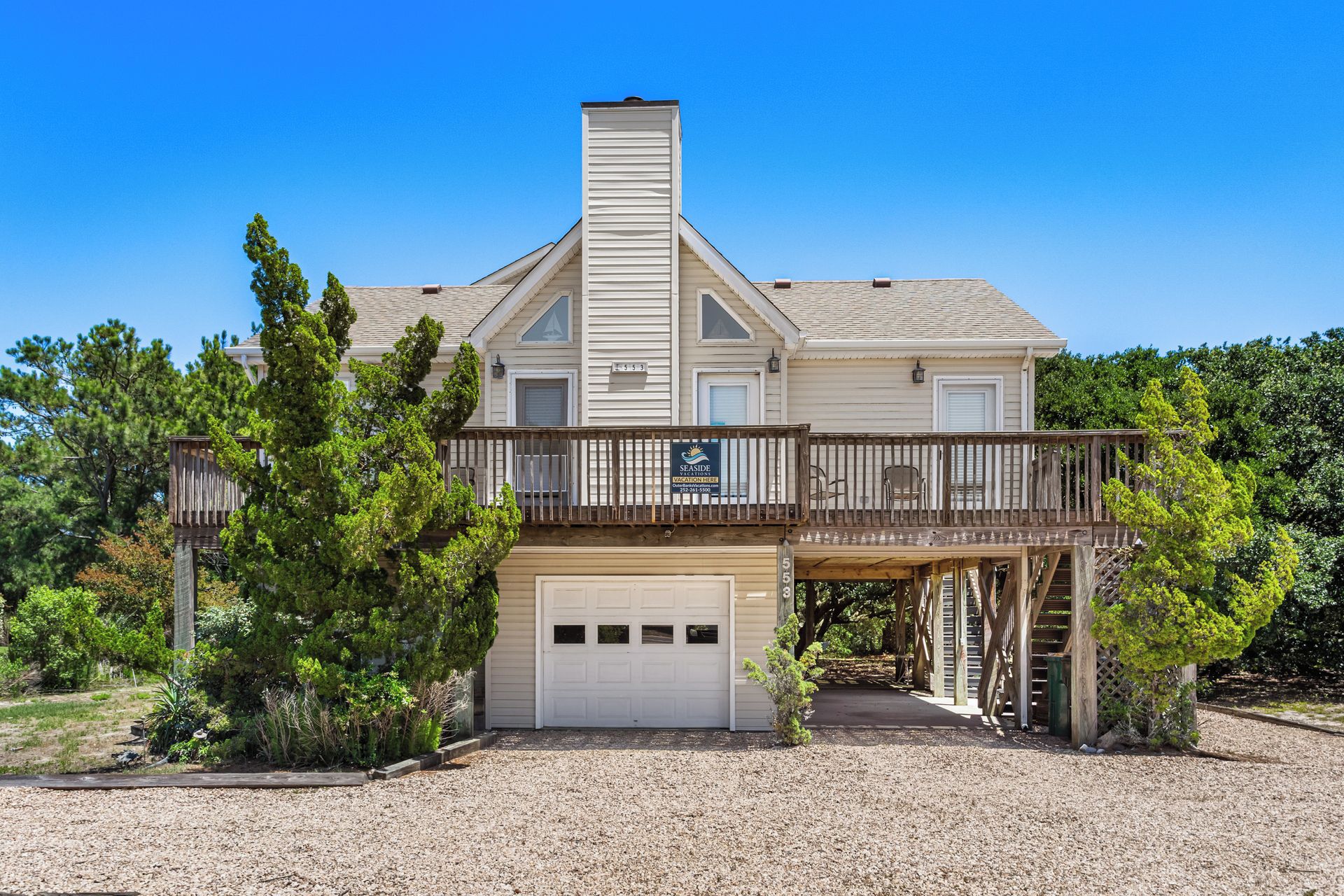 A two-story house with a covered front porch and a garage.
