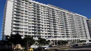 A large, multi-story hotel with numerous balconies and a central courtyard. - Pavilion by Design Suites Miami (Miami Beach)