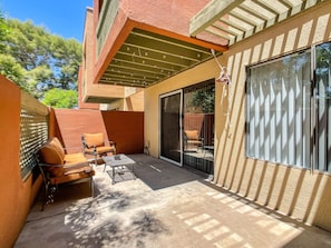 A patio with outdoor furniture, a pergola, and a sliding glass door. - Sunscape Unwind - resort community! (Scottsdale)