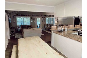 Relax in this inviting living area with a kitchen, dining table, and comfortable seating options.