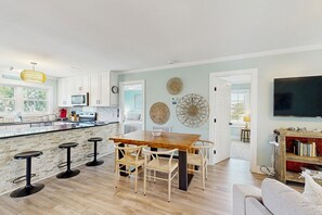 Enjoy cooking in this well-equipped kitchen with a central island, bar stools, and a large table.