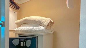 A compact, modern laundry room with a built-in washer and dryer, a small storage drawer, and a towel rack above the dryer. - MGM Signature Balcony Suite 5073 NO RESORT FEE (Las Vegas)