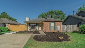 A residential house with a front yard, a driveway, and a wooden fence. - Welcoming Woodmere Wonder, WiFi, Pool & Parking (Montgomery)
