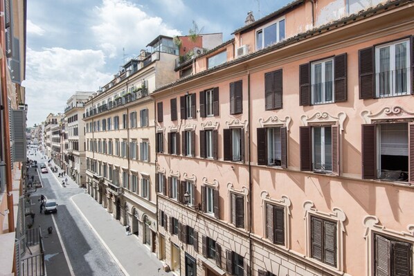 A row of multi-story buildings with uniform architectural style, featuring balconies and large windows. - Spanish Steps Luxury Fashion Apartment (Roma)