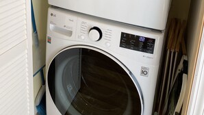 A stacked washer and dryer unit with a control panel displaying various settings. - Hampton Bays Family Summer Home (Hampton bays)