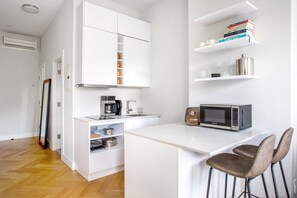 Fridge, microwave, coffee/tea maker, cookware/dishes/utensils