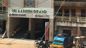 A building with a sign reading "Sri Aadhish Grand".