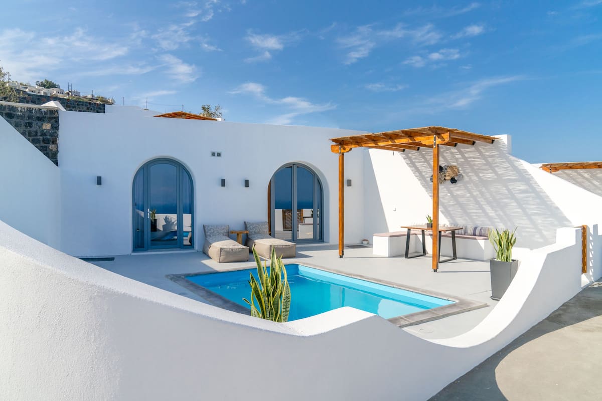 A modern villa with a swimming pool, outdoor seating, and a pergola.