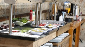 A buffet setup with various food items and condiments. - Castle Inn Boutique Hotel (Antalya)