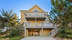 A two-story building with a balcony, a sign indicating availability for rent, and a staircase leading to the entrance. - 6154 Little Sushi * 2 Min Walk to Beach (Nags Head)