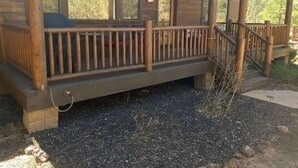 A wooden cabin with a porch, large windows, and a stone foundation. - Great Cabin in Torreon Community of Show Low (Show Low)