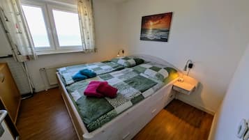 Cozy bedroom with double bed and large window