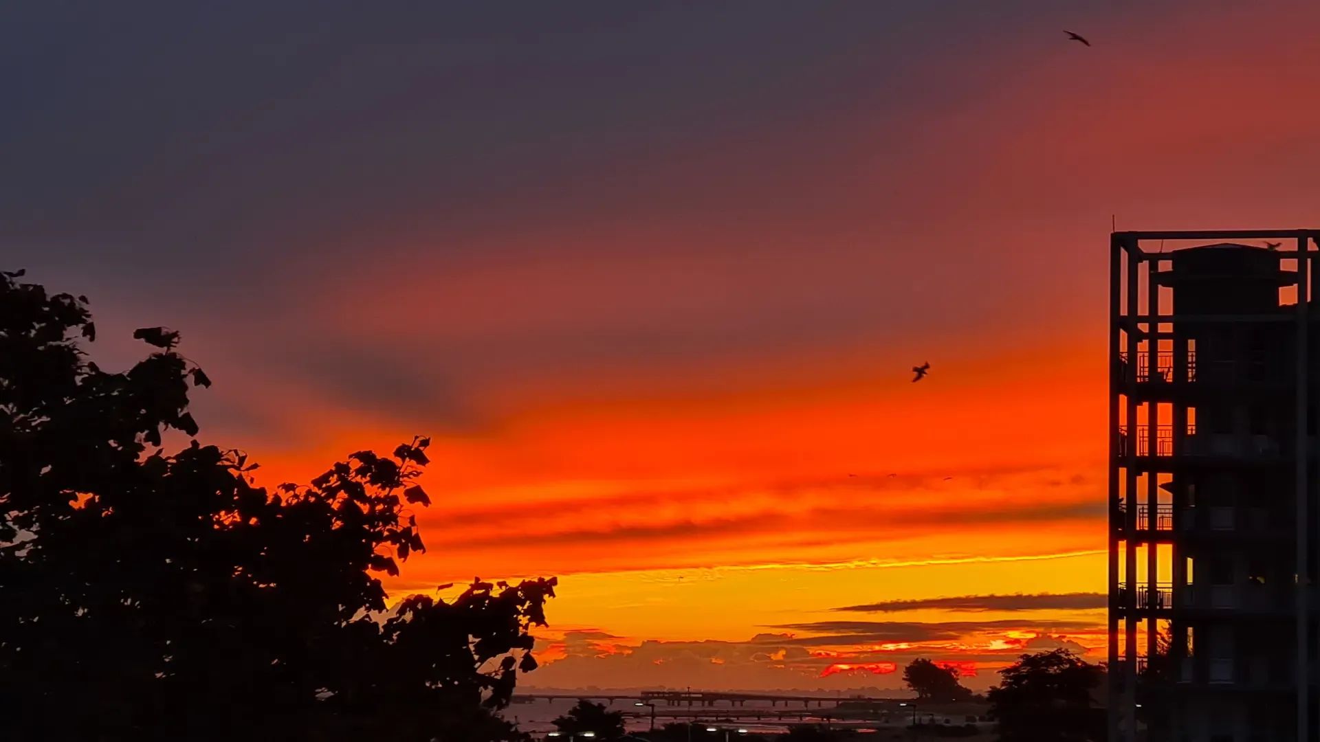 Intense sunrise with silhouettes of the Baltic Sea Residence buildings