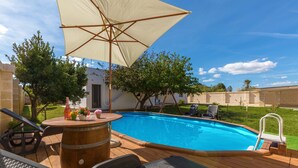 A wooden deck with a pool, outdoor furniture, and a pergola with a canopy. - 2092 Villa Il Fenicottero Salentino (Manduria)