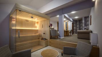 A modern interior with a sauna, seating area, and a living space.