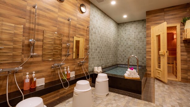 Un baño moderno con paredes de madera, una bañera grande y una zona de ducha separada.