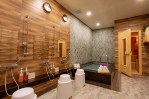 A modern bathroom with wooden walls, a large bathtub, and a separate shower area. - Hotel Kuretakeso Thailand Sriracha (Si Racha)