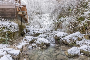 A snow-covered outdoor area with a wooden staircase leading up to a building.
