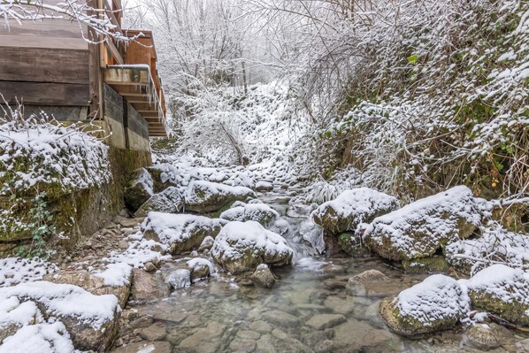 A snow-covered outdoor area with a wooden staircase leading up to a building.