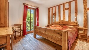 A wooden-framed room with a bed, a desk, and a chair. - House By The Stream in Soca Valley (Kanal)
