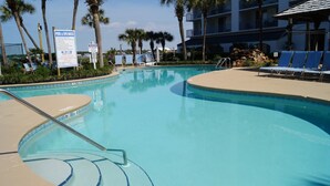 A swimming pool with lounge chairs and palm trees. - Gulf Shores Surf & Racquet Club 212A (Gulf Shores)