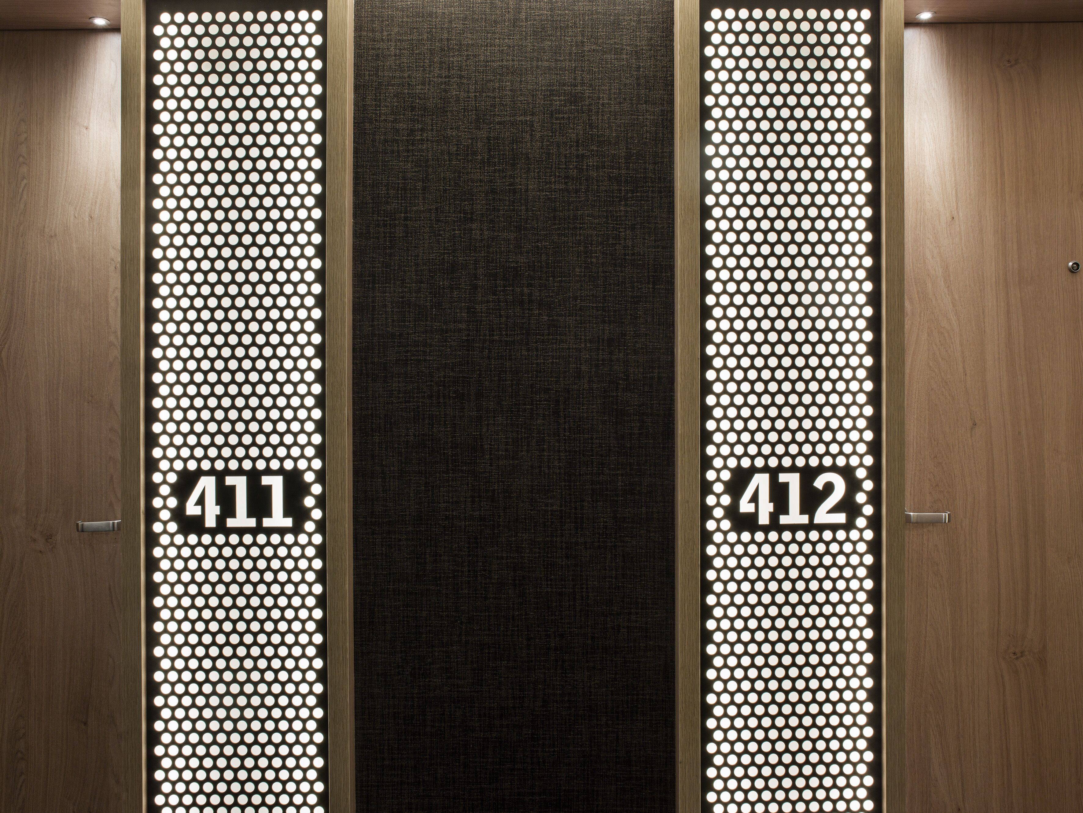 A hotel entrance with two doors, each marked with a number (411 and 412) and a dot pattern design.