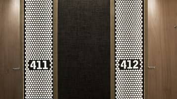 A hotel entrance with two doors, each marked with a number (411 and 412) and a dot pattern design.