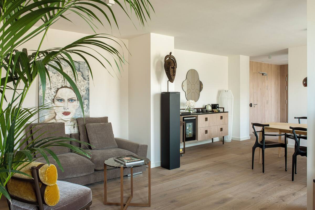 A modern living room with a sofa, coffee table, and dining area.