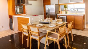 A modern kitchen with wooden cabinets, a built-in oven, a microwave, and a refrigerator. - Penthouse Overlooking Ipanema Beach Vsc2 (Rio de Janeiro)