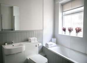 Combined shower/bathtub, towels, soap, toilet paper