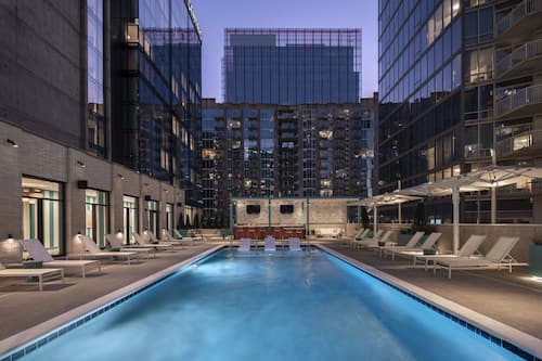 Seasonal outdoor pool, open 7:00 AM to 10:00 PM, pool umbrellas