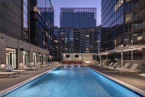 Seasonal outdoor pool, open 7:00 AM to 10:00 PM, pool umbrellas