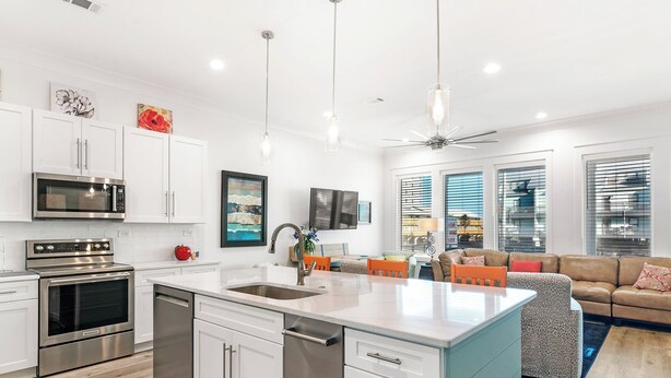 A modern kitchen with white cabinets, stainless steel appliances, and a large island. - 😎 Night Heron, East. ⭐️⭐️⭐️⭐️⭐️ 6BR. Heated Pool. Beachview. Gorgeous! (Gulf Shores)
