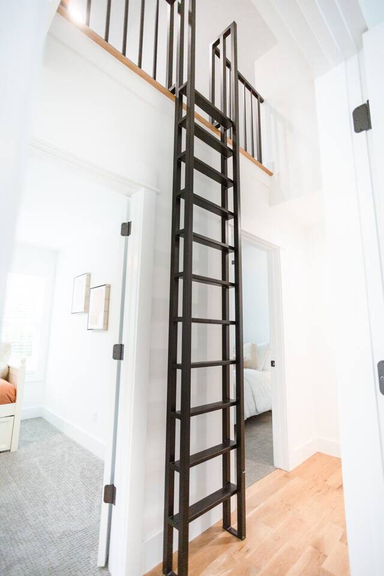 A modern interior with a wooden staircase leading to a loft area.