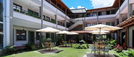 A courtyard with outdoor seating, multiple levels, and a central staircase.
