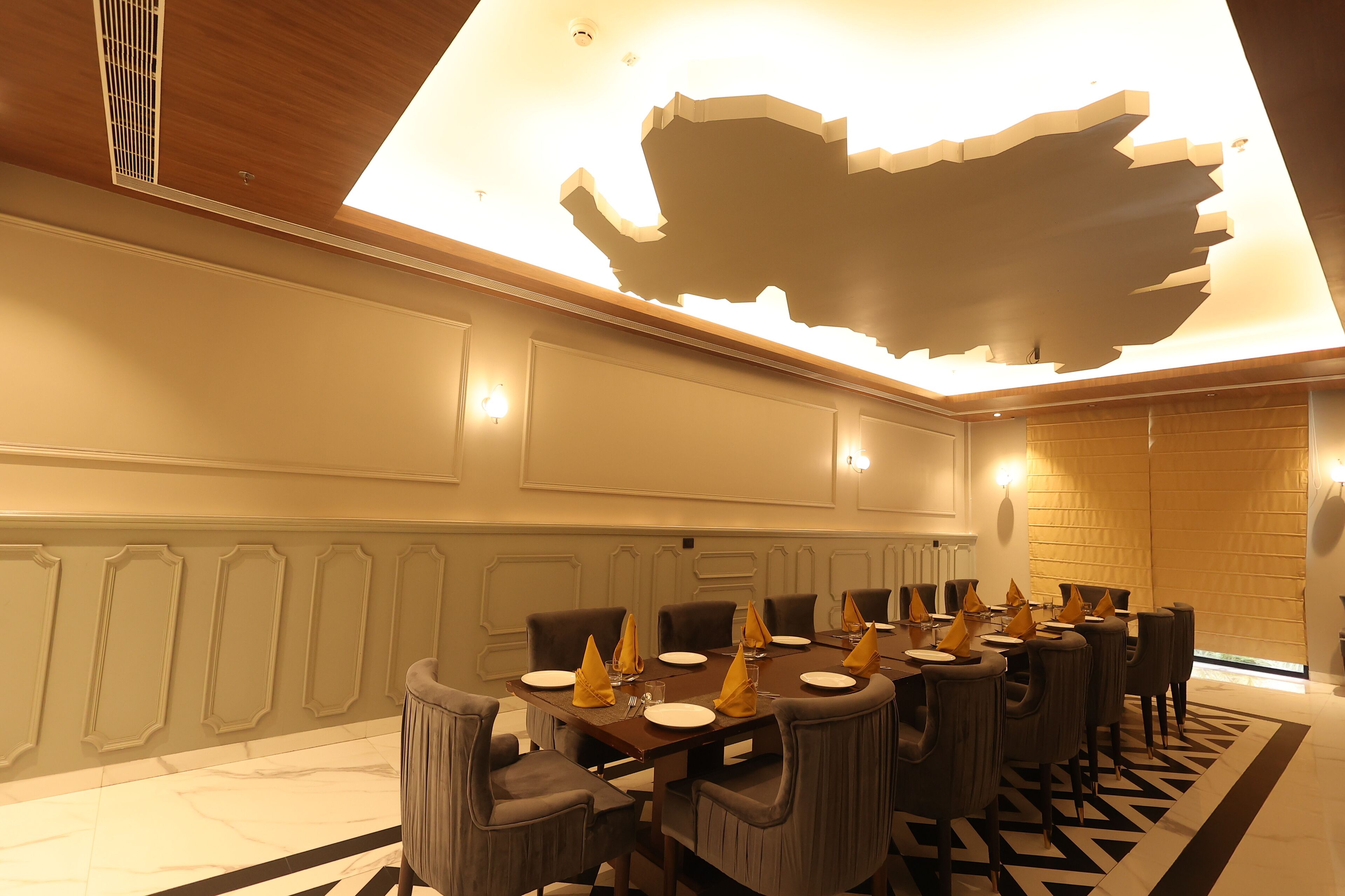 A dining area with a long table set for a meal, surrounded by chairs.