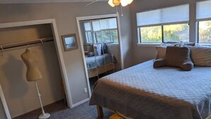 A bedroom with a bed, a chair, a desk, a wardrobe, and a window. - Cozy 3-Bdrm  Escape w/ Yard - Budget-Friendly (Austin)