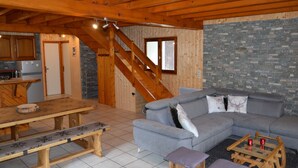 A wooden interior with a dining table, bench, sofa, and a staircase. - WARM ALTITUDE BARN, Cambasque, 8 people (Cauterets)